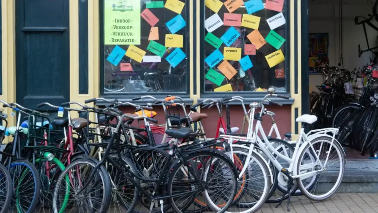 A row of second-hand bicycles for sale outside a bike shop