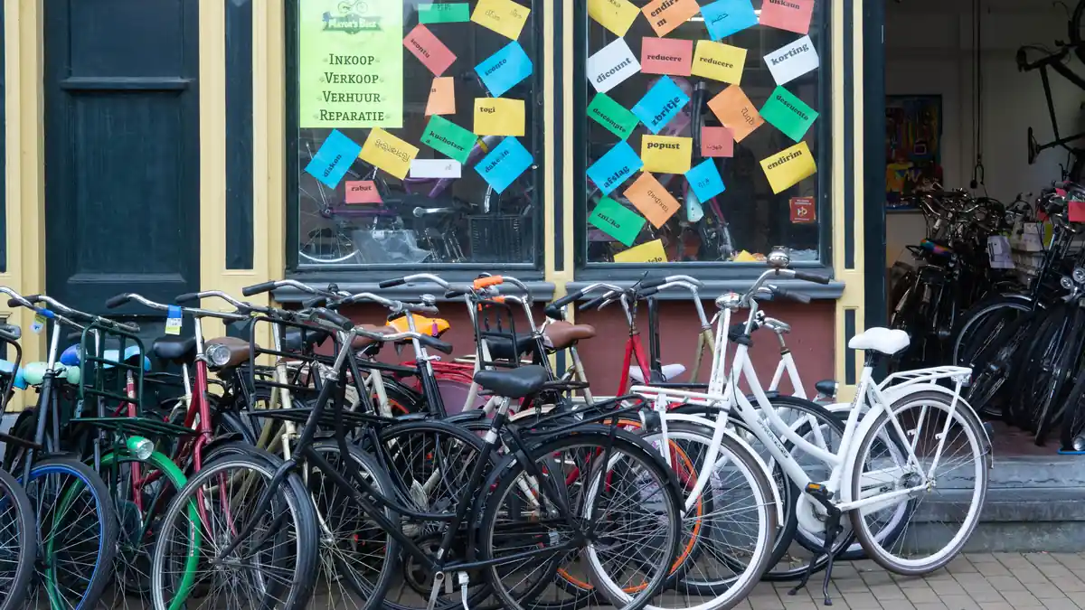 A row of second-hand bicycles for sale outside a bike shop