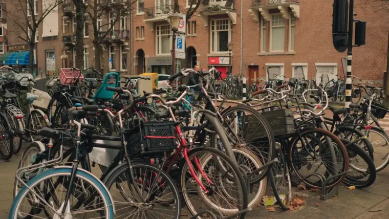 A large bicycle parking area full of commuter bikes