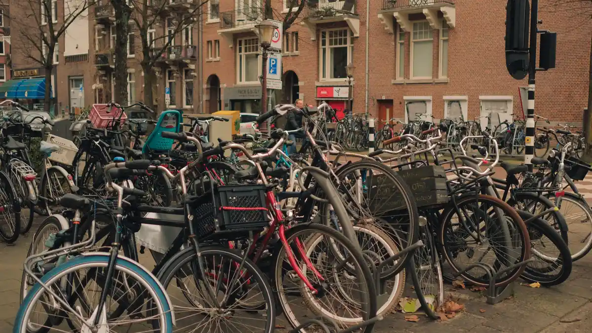 A large bicycle parking area full of commuter bikes