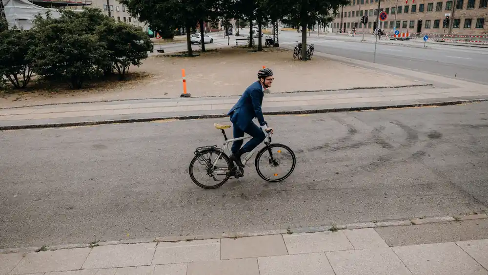 A commuter in a suit cycling to work