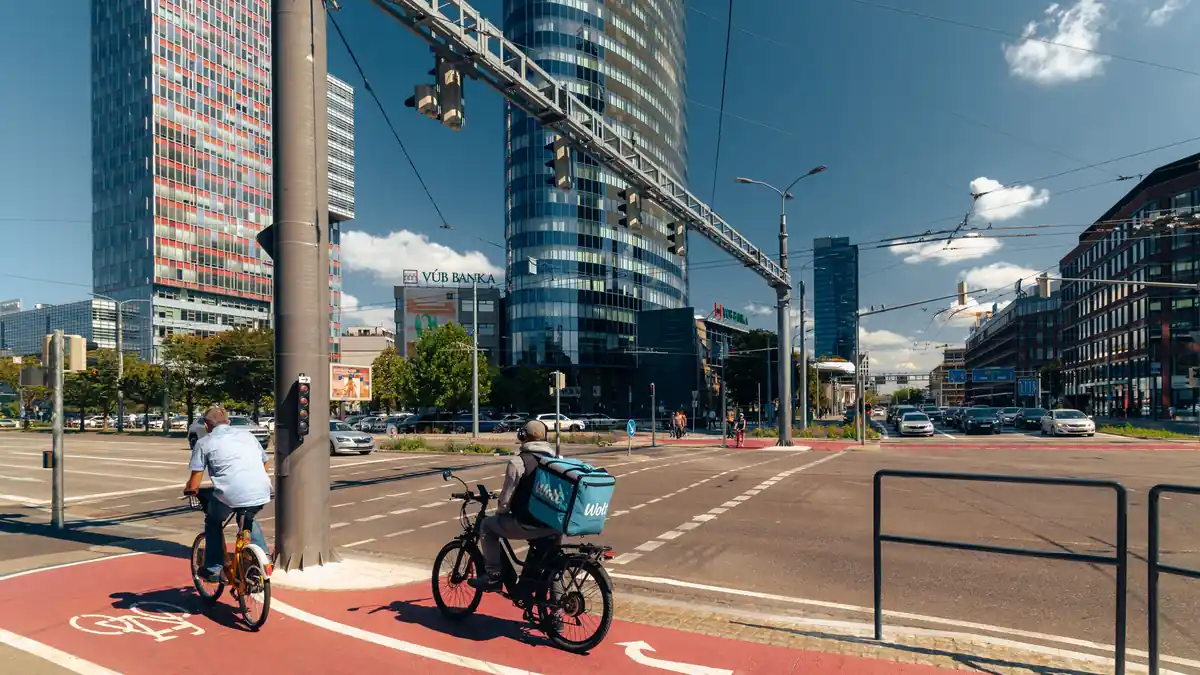 Commuters riding in a cycle lane through a city business district