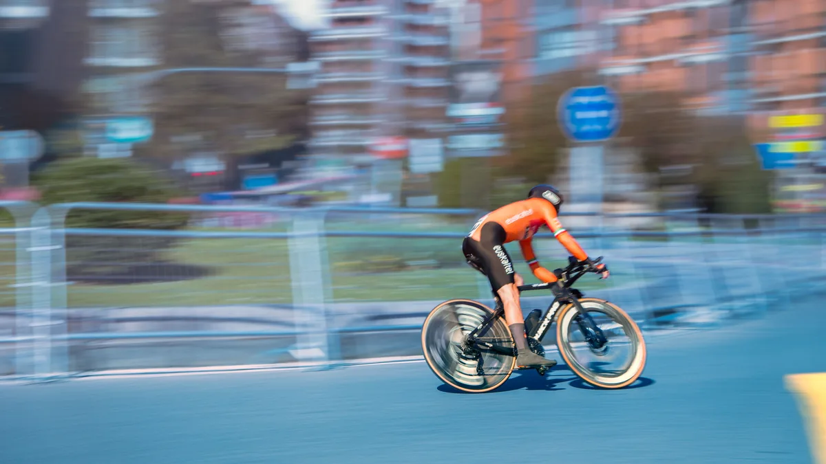 A cyclist riding at speed on the road