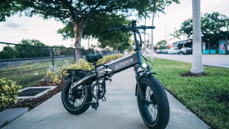 A folding electric bike parked on a path