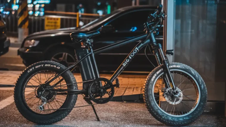 Commuter riding an electric bike along a city street