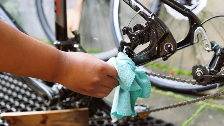 Cleaning a bike chain with a brush and degreaser