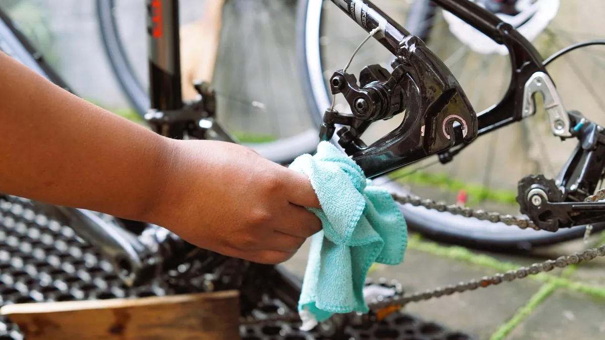 Cleaning a bike chain with a brush and degreaser
