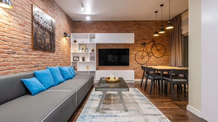A bicycle stored on a wall-mounted hook in a home hallway