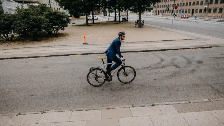 Cyclist commuting to work on a busy UK street