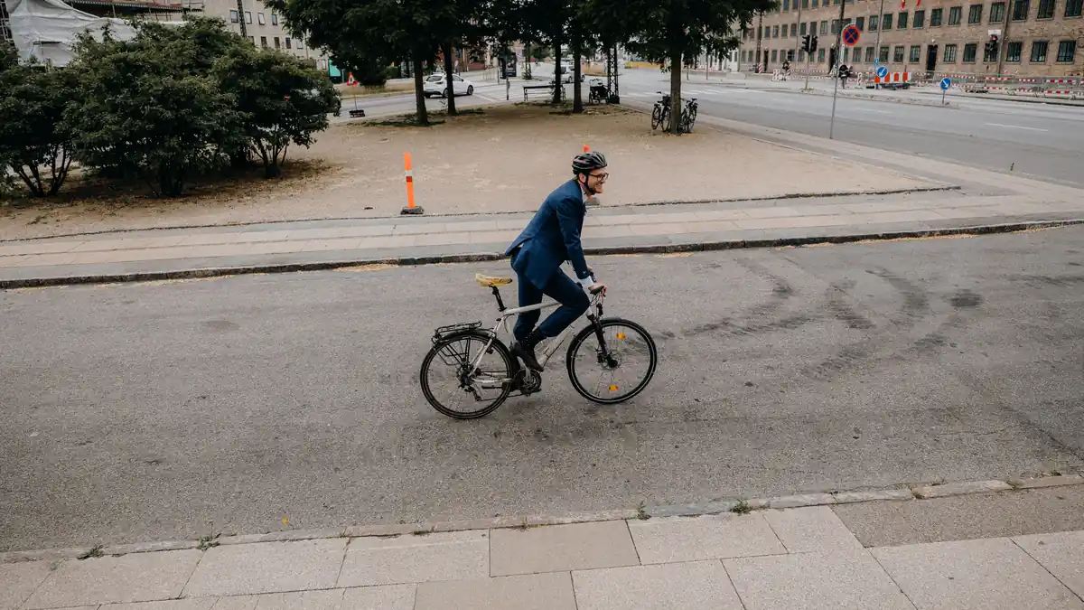 Cyclist commuting to work on a busy UK street