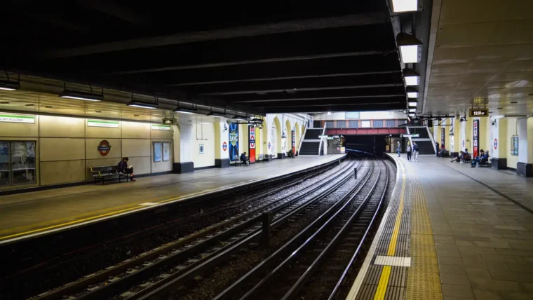 Commuter folding a bike at a UK railway station platform