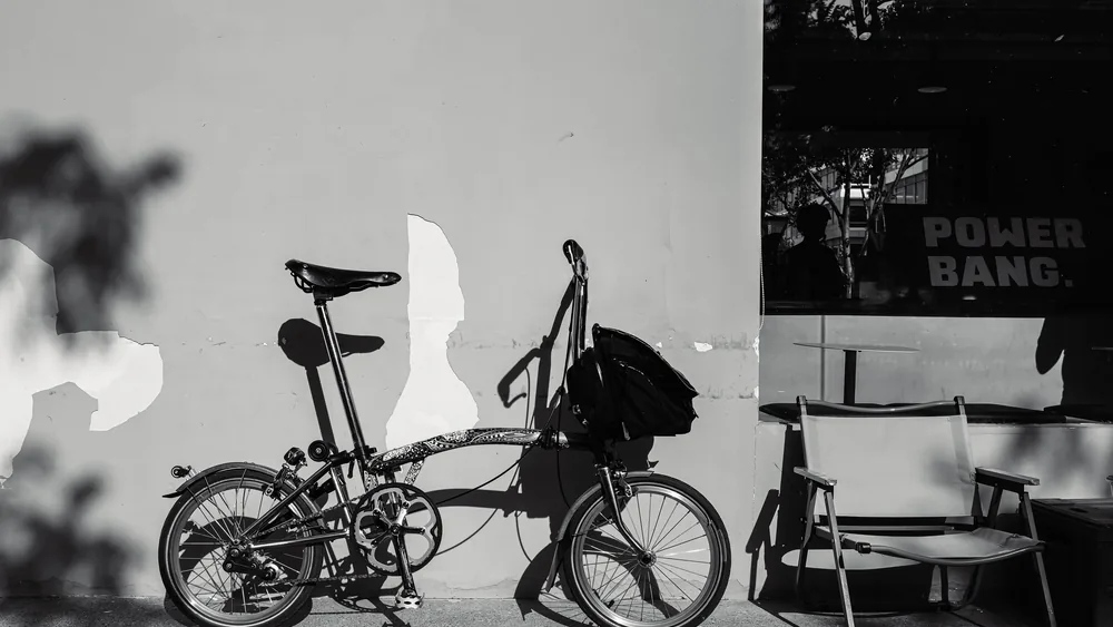 Person cycling a folding bike through a city street