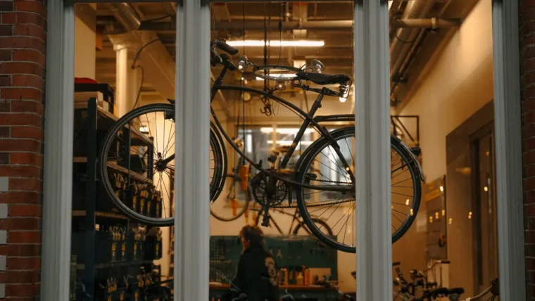 A bike mechanic servicing a bicycle in a workshop