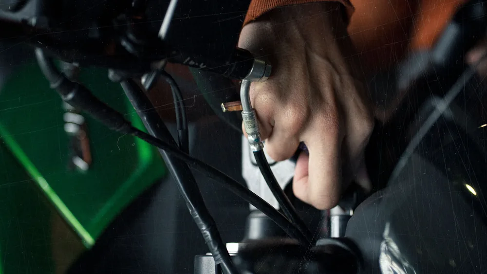 Adjusting bicycle brakes and gear cables during a bike service