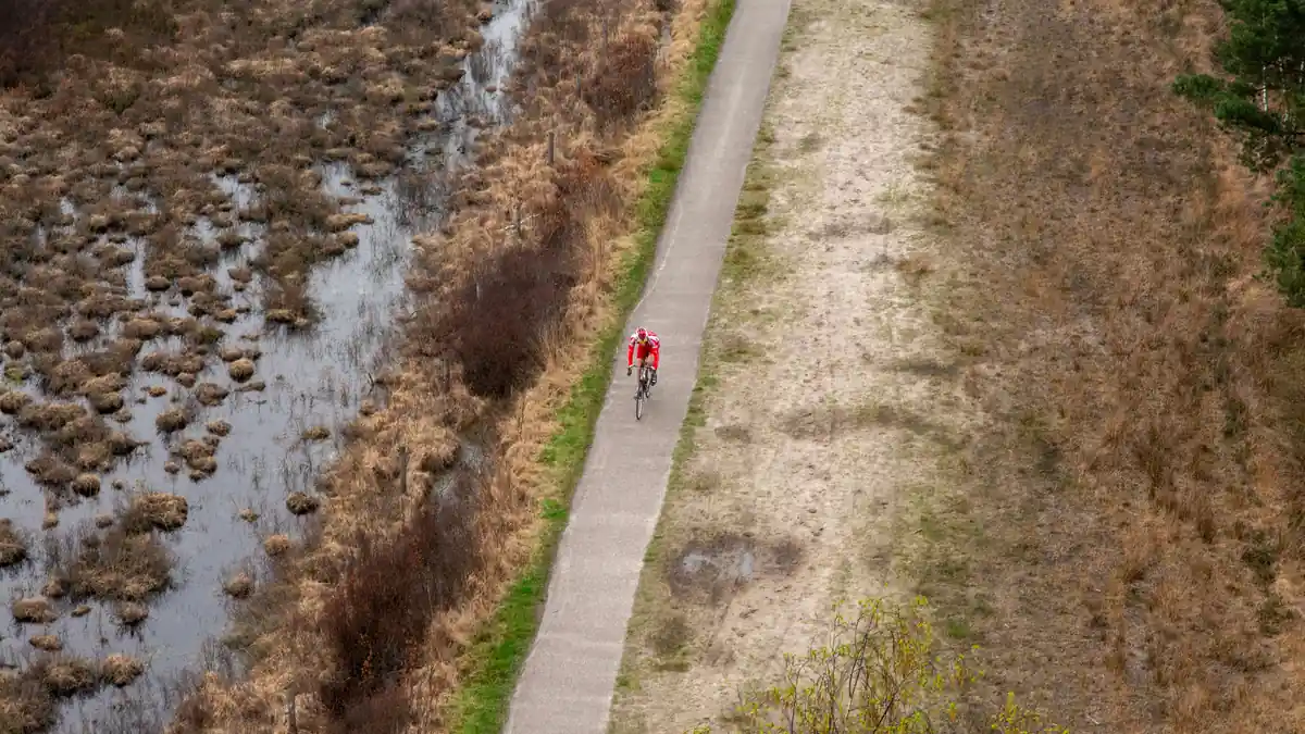 Cyclist riding on a dedicated cycle path, part of the National Cycle Network in the UK