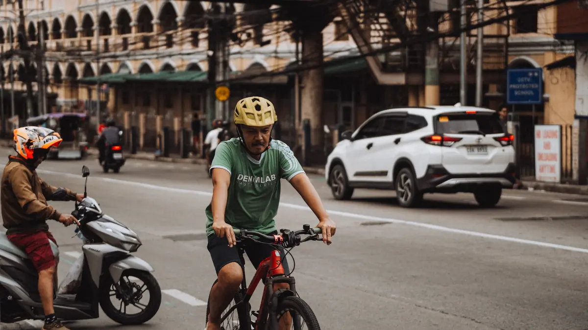 Cyclist wearing a helmet on an urban commute in the UK