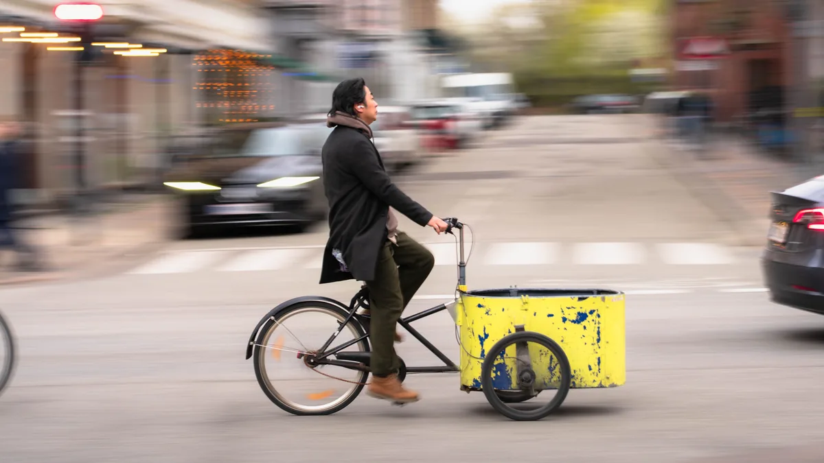 Cargo bike being ridden through a city street