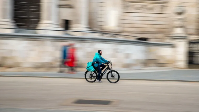 A commuter cycling to work along a city street in the UK